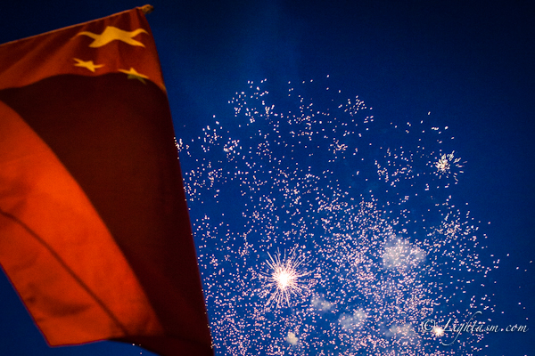 Fireworks behind Chinese Flag